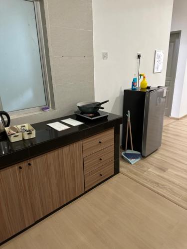 a kitchen with a counter with a bowl on it at Ayaan Snookers Home 3 at Quintet Apartment with Private Parking in Tanah Rata