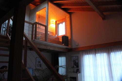 a staircase in a house with a window and a stair case at Königin der Alpen in Beatenberg