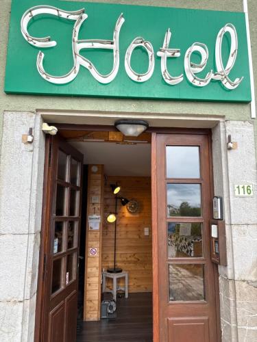 a sign above the door of a coffee shop at Le Saint Vincent in Apremont