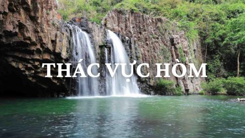 a waterfall in the jungle with the words vacation home at HAKU Boutique Hotel Tuy Hoà - APEC Mandala in Tuy Hoa