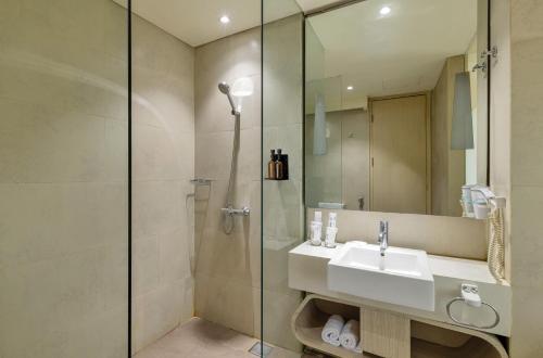 a bathroom with a sink and a shower at Artotel Harmoni Jakarta in Jakarta