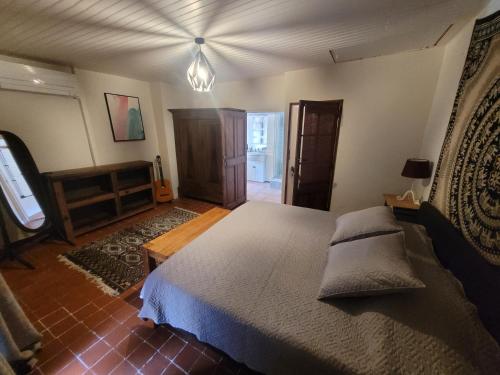 a bedroom with a large bed in a room at The Cozy Collo House in Collobrières