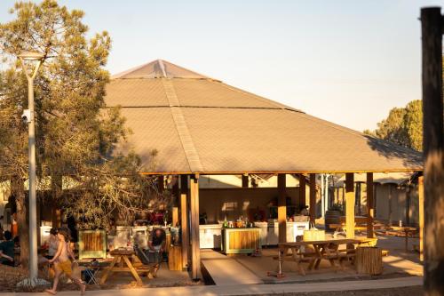 a pavilion with people walking in front of it at Ortal Glamping in Ortal