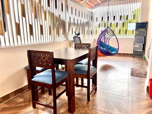 a wooden table and chairs in a room at Nanis Villa in Anantapur