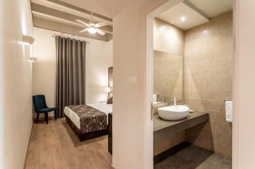 a bathroom with a bed and a sink and a mirror at Notre Dame of Jerusalem Center in Jerusalem
