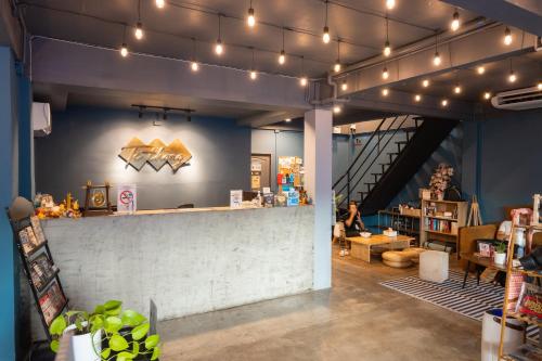 a store with a counter in a room with lights at Ti Thong Hostel in Bangkok