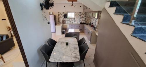 an overhead view of a kitchen with a table and chairs at Suhana Aangan Rooms and Villa 