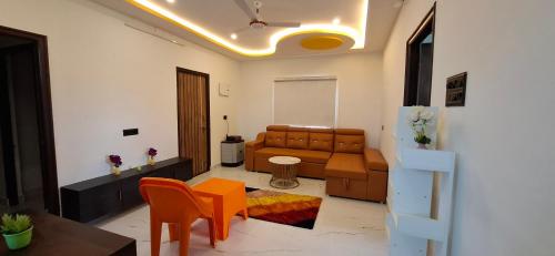 a living room with a couch and a table at Suhana Aangan Rooms and Villa 