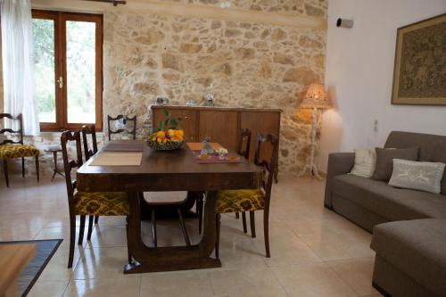 a living room with a table and a couch at Cretan cottage of 1900 with beautiful olive yard in Kissamos