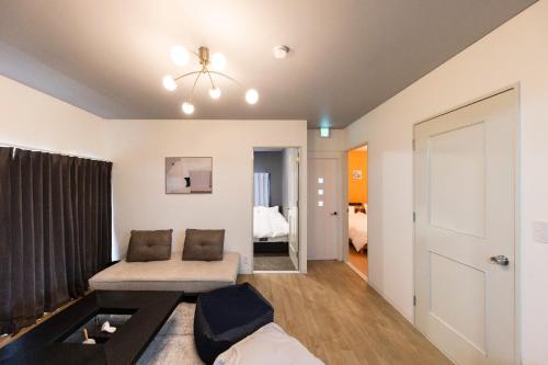 a living room with a couch and a table at Lights YADO Akasaki - Vacation STAY 15901 in Sasebo