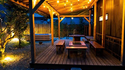 a wooden porch with benches and lights on it at CampBaseKadojin - Vacation STAY 33535v in Tenkawa