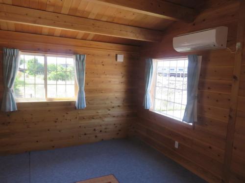 a room in a log cabin with two windows at Tokai Beach Outdoor Campsite Mori no Shonen Oji - Vacation STAY 42348v in Noma