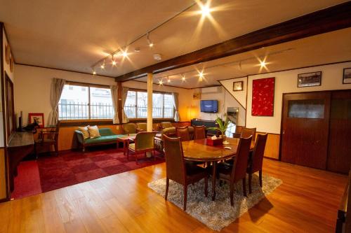 a dining room and living room with a table and chairs at Kodatel Hakodate Daimon - Vacation STAY 15893 in Shinkawachō