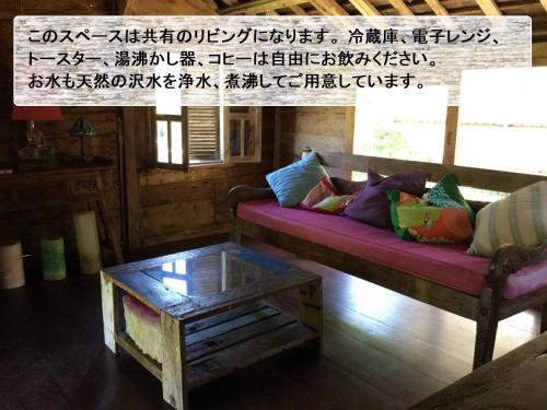 a living room with a couch and a coffee table at Nature Lodge Niji no Mame - Vacation STAY 45236v in Fukai