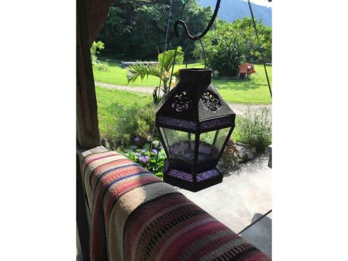 a black lantern hanging from a window with a yard at Nature Lodge Niji no Mame - Vacation STAY 45236v in Fukai
