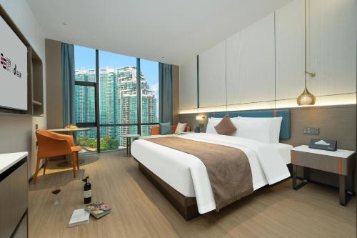 a hotel room with a large bed and a desk at Yizhi Hotel - Guangzhou Shamian Island Huangsha Metro Station-Canton Fair free shuttle bus included Breakfast in Guangzhou