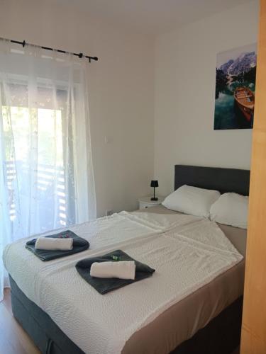 a bedroom with a bed with two towels on it at Studio apartman Hušnjakovo Hill in Krapina
