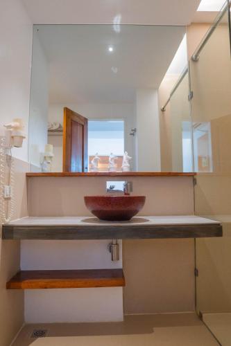 a bathroom with a sink and a mirror at The Paragon Boracay Suites in Boracay