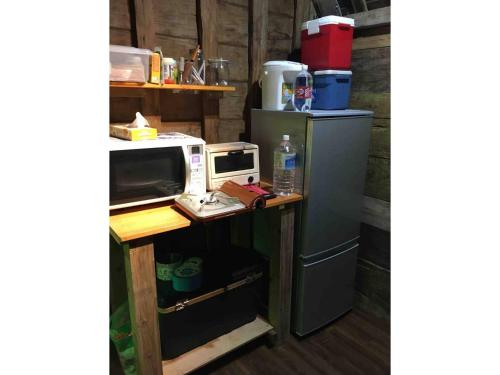 a microwave on a counter next to a refrigerator at Nature Lodge Niji no Mame - Vacation STAY 45233v in Fukai
