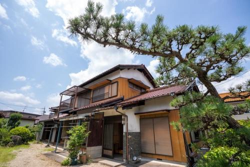 a house with a tree in front of it at Hanareya Hyō - Vacation STAY 49547v in Nakatsugawa