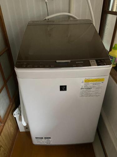 a laptop computer sitting on top of a refrigerator at Shikoku no minami - Vacation STAY 49277v in Shishikui