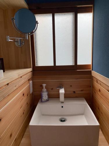 a bathroom with a white sink and a mirror at Shikoku no minami - Vacation STAY 49277v in Shishikui