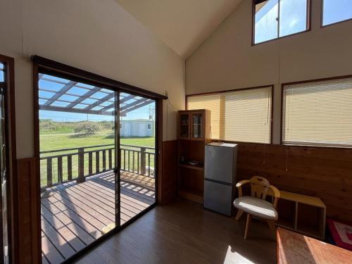 a kitchen with a sliding glass door to a balcony at Hasaki Seaside Campsite - Vacation STAY 51111v in Shari