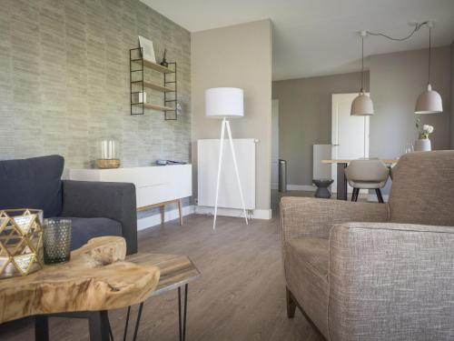 a living room with a couch and a table at Apartment in tasteful farmhouse in De Cocksdorp, on the Wadden island of Texel in De Cocksdorp