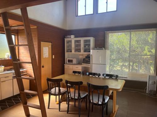 a kitchen with a table and chairs and a refrigerator at Hasaki Seaside Campsite - Vacation STAY 51110v in Shari