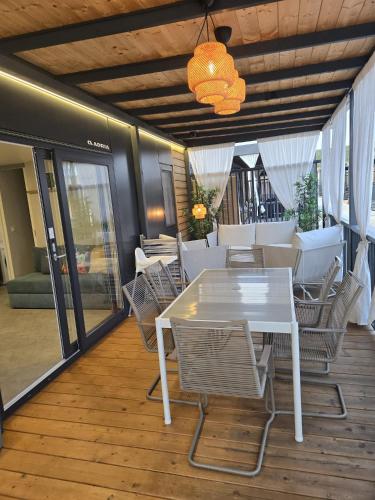 a white table and chairs on a wooden deck at Mobile Home Sea Breeze in Sveti Petar