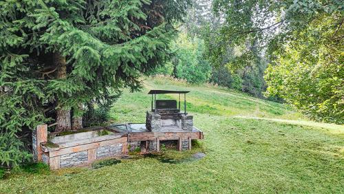 a tractor sitting in the grass in a field at Chalet Marinette in Icogne