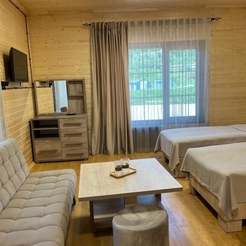 a hotel room with two beds and a couch at GreenWood in Dilijan