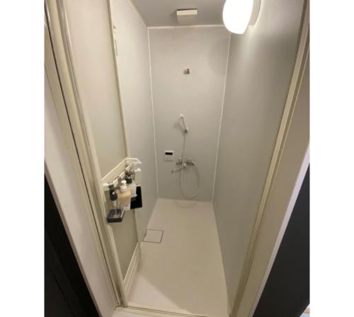 a white bathroom with a shower and a toilet at Maison de Sato - Vacation STAY 16105 in Nabegayato