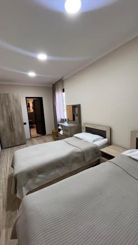 a hotel room with three beds in a room at GreenWood in Dilijan