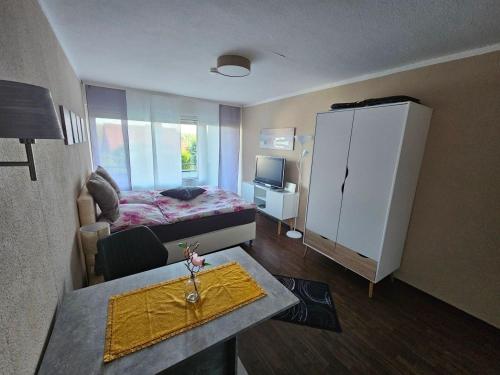 a small room with a bed and a table in it at Ferienwohnung Kempe - Hagebuttenweg in Bad Lauterberg
