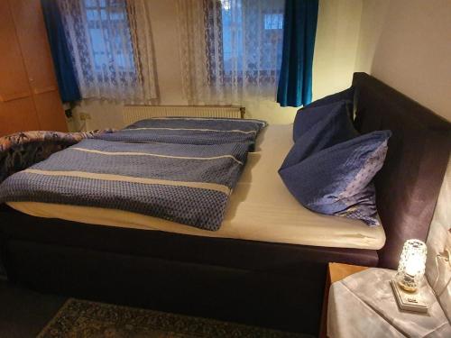 a bed with two pillows on it in a room at Ferienwohnungen Kempe - Hauptstraße in Bad Lauterberg