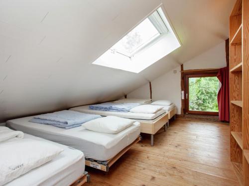 three beds in a room with a skylight at Heritage Holiday Home in Roumont in Roumont