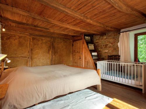 a bedroom with a bed and a crib at Heritage Holiday Home in Roumont in Roumont