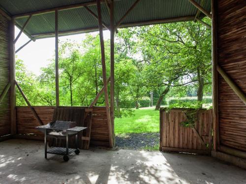 a screened in porch with a table in it at Heritage Holiday Home in Roumont in Roumont