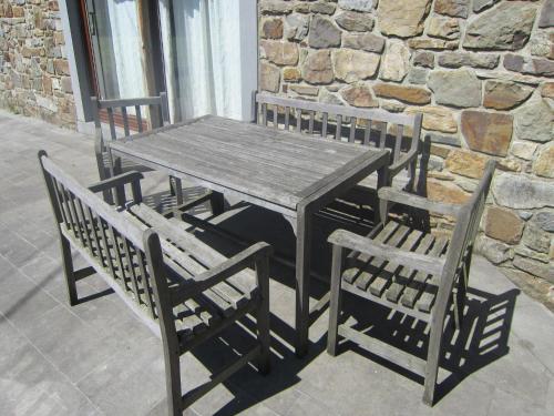 a wooden table and two chairs and a table and chairs at Heritage Holiday Home in Roumont in Roumont