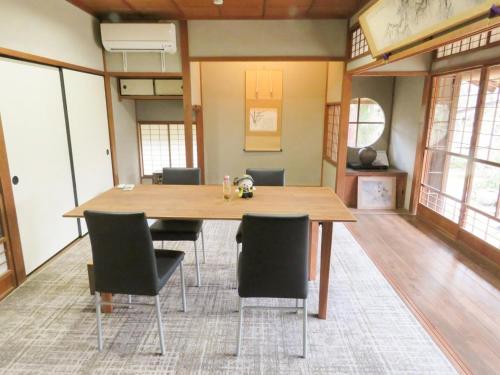 a dining room with a wooden table and chairs at Hagi no Oyado Hananari no Niwa - Vacation STAY 16121 in Hagi