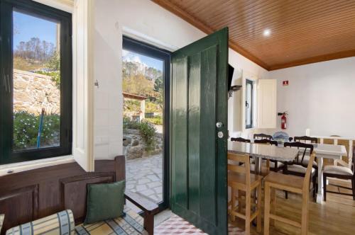 a green door leading to a kitchen and dining room at Quintinha de Pinouco in Resende