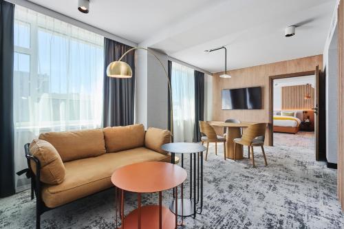 a living room with a couch and a table at voco Katowice by IHG in Katowice