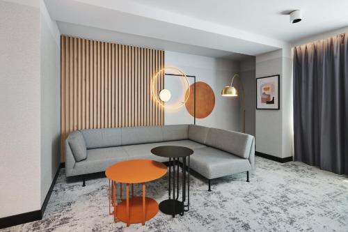 a living room with a couch and a table at voco Katowice by IHG in Katowice