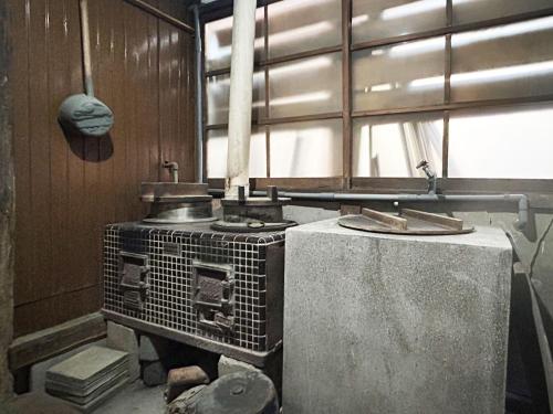 an old stove in a room with a window at Nano Village Okayama - Vacation STAY 66531v in Kaga