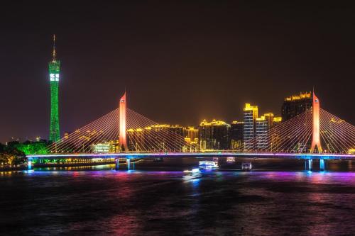 a bridge over a river with a city at night at Yizhi Hotel - Guangzhou Shamian Island Huangsha Metro Station-Canton Fair free shuttle bus included Breakfast in Guangzhou