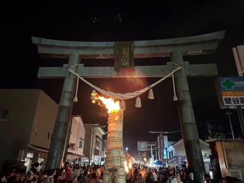 a crowd of people standing around a pillar with a fire at Guest House Fuji no Yado Akebono Building A - Vacation STAY 74316v in Fujiyoshida