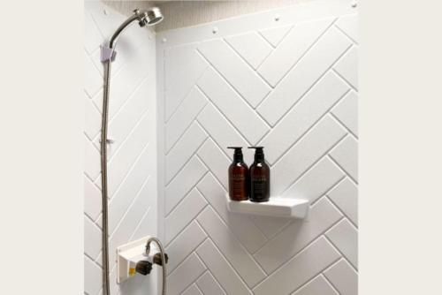 a bathroom with two bottles on a wall at LUCY RESORT - Vacation STAY 77592v in Kamigō
