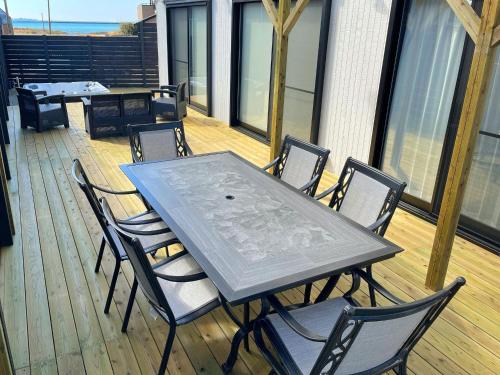 a table and chairs on the deck of a house at PRIVATE VILLA NAGI - Vacation STAY 75390v in Tateyama