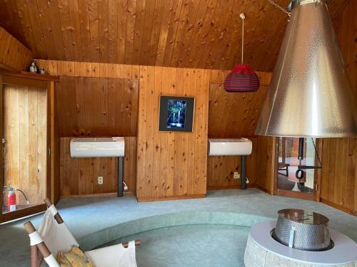 a room with wooden walls and a lamp and a table at HANAMIDORI Soshino Sanso - Vacation STAY 16181 in Gujo